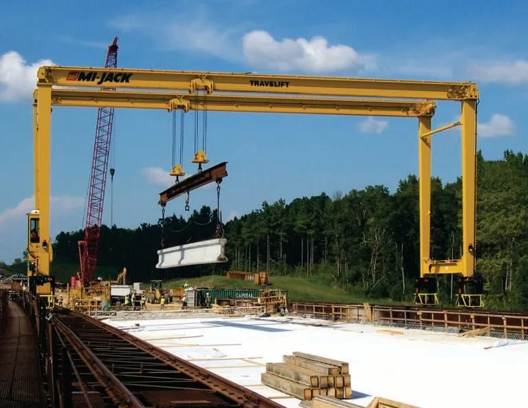 travelift lifting steel beam on bridge project