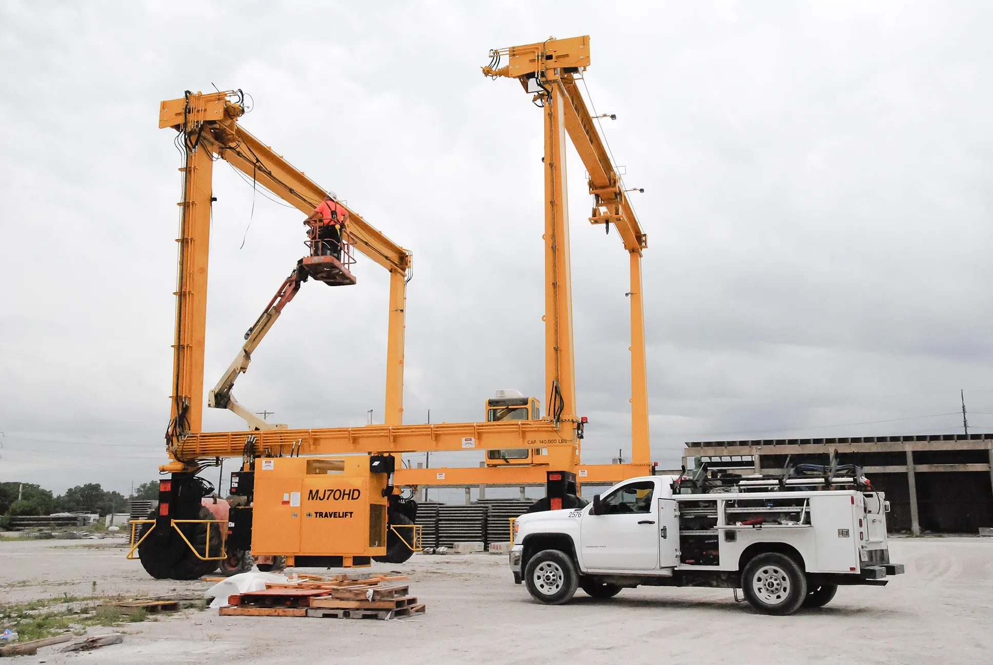 a mi-jack service truck servicing a mj70hd travelift rtg