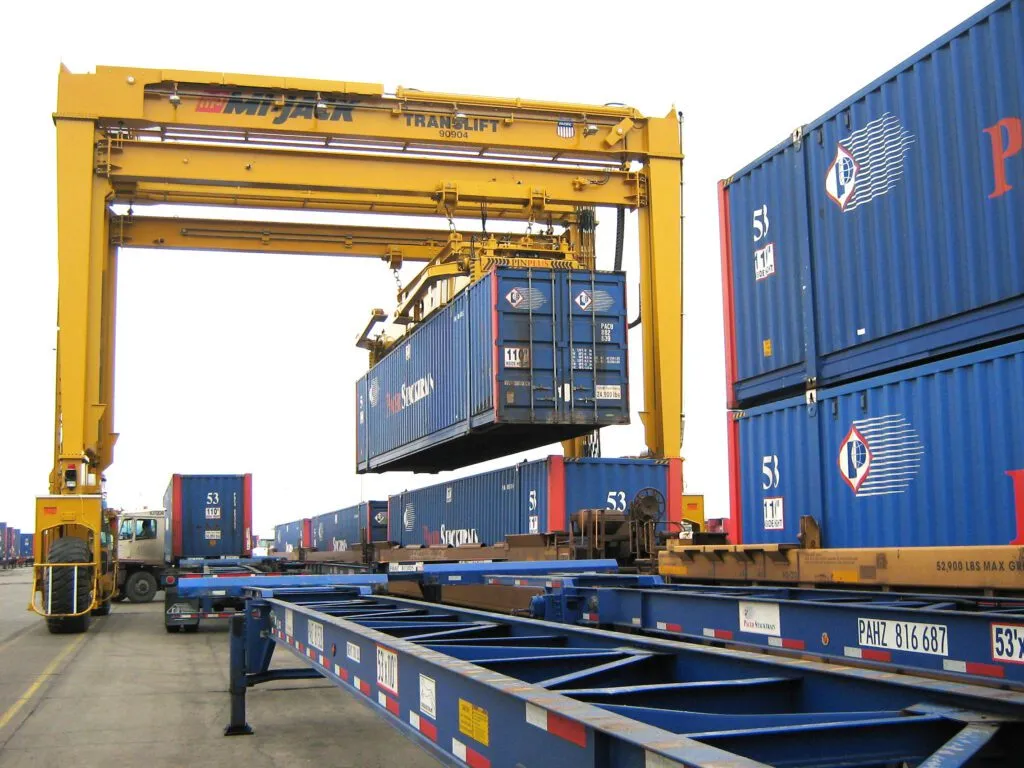 yellow mj1200r moving blue shipping container