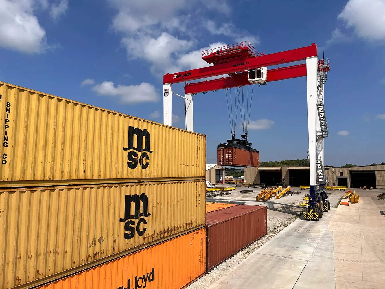 mi-jack jl1400p next to yellow and orange containers